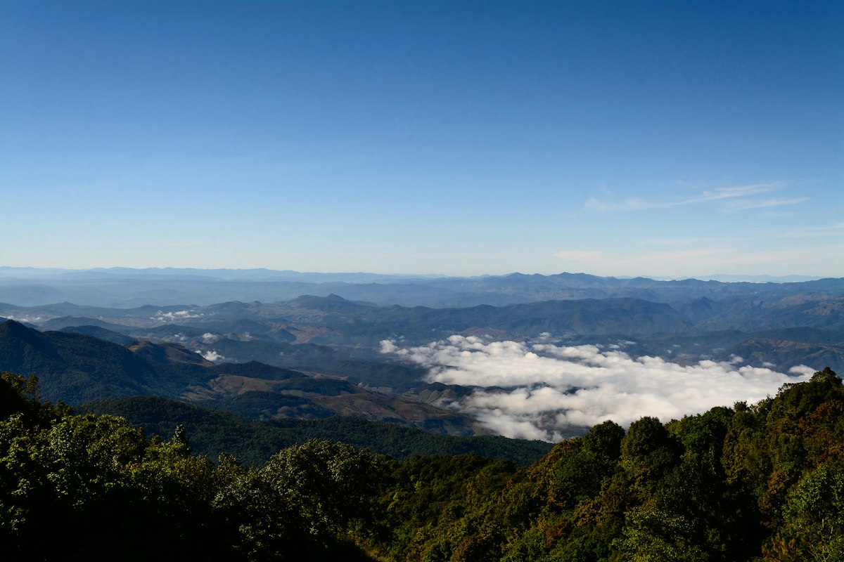 Misty mountains and forest seen from a hilltop near Chiang Mai
