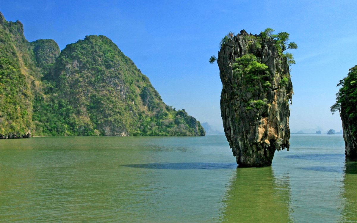 Limestone sea stack and green cliffs in the Andaman Sea