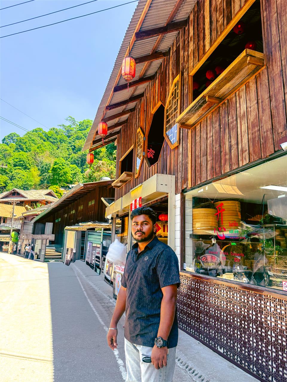 Wooden shop fronts with red lanterns in Mae Kampong village near Chiang Mai