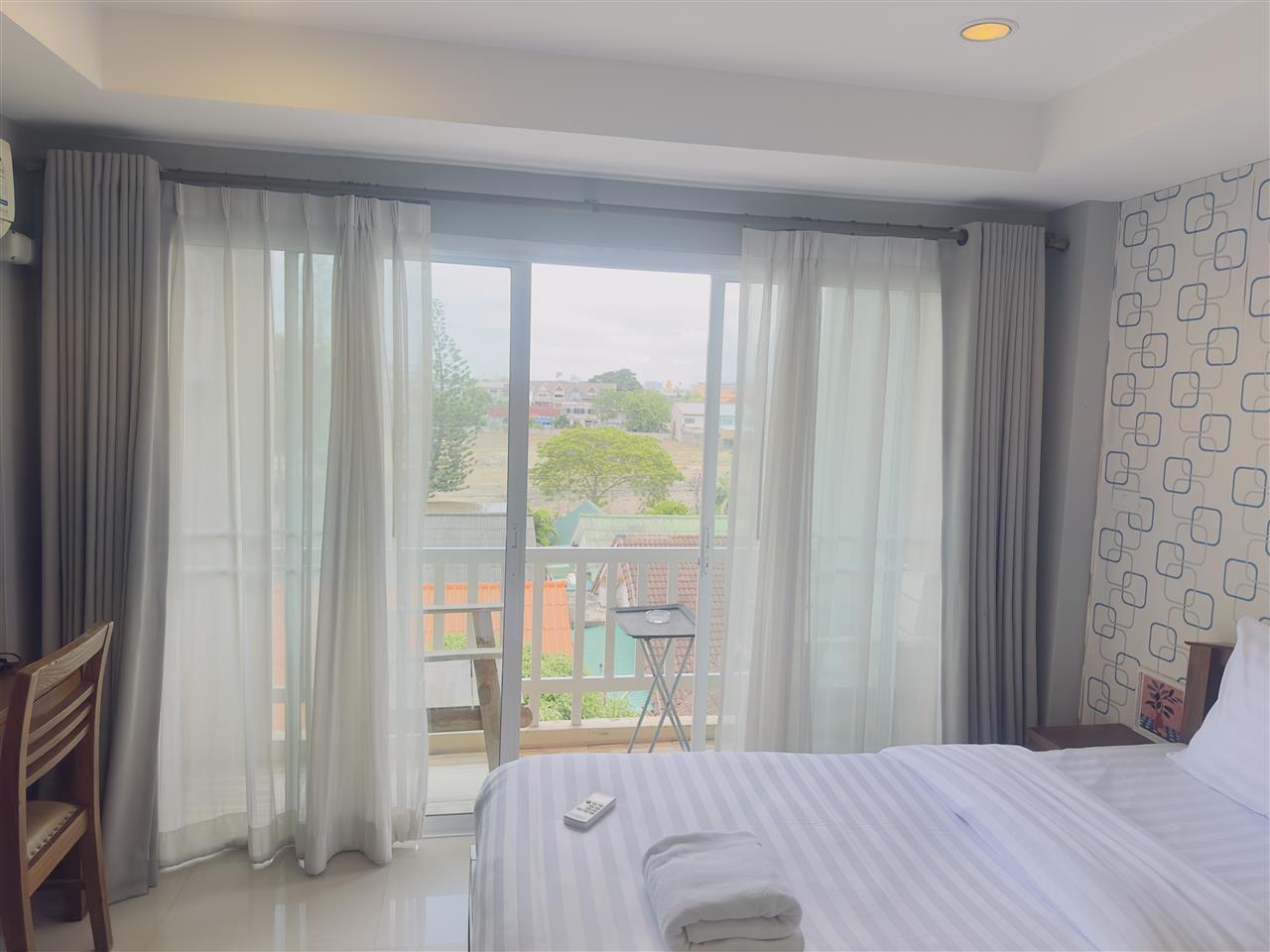 Hotel room with a sliding balcony door and curtains
