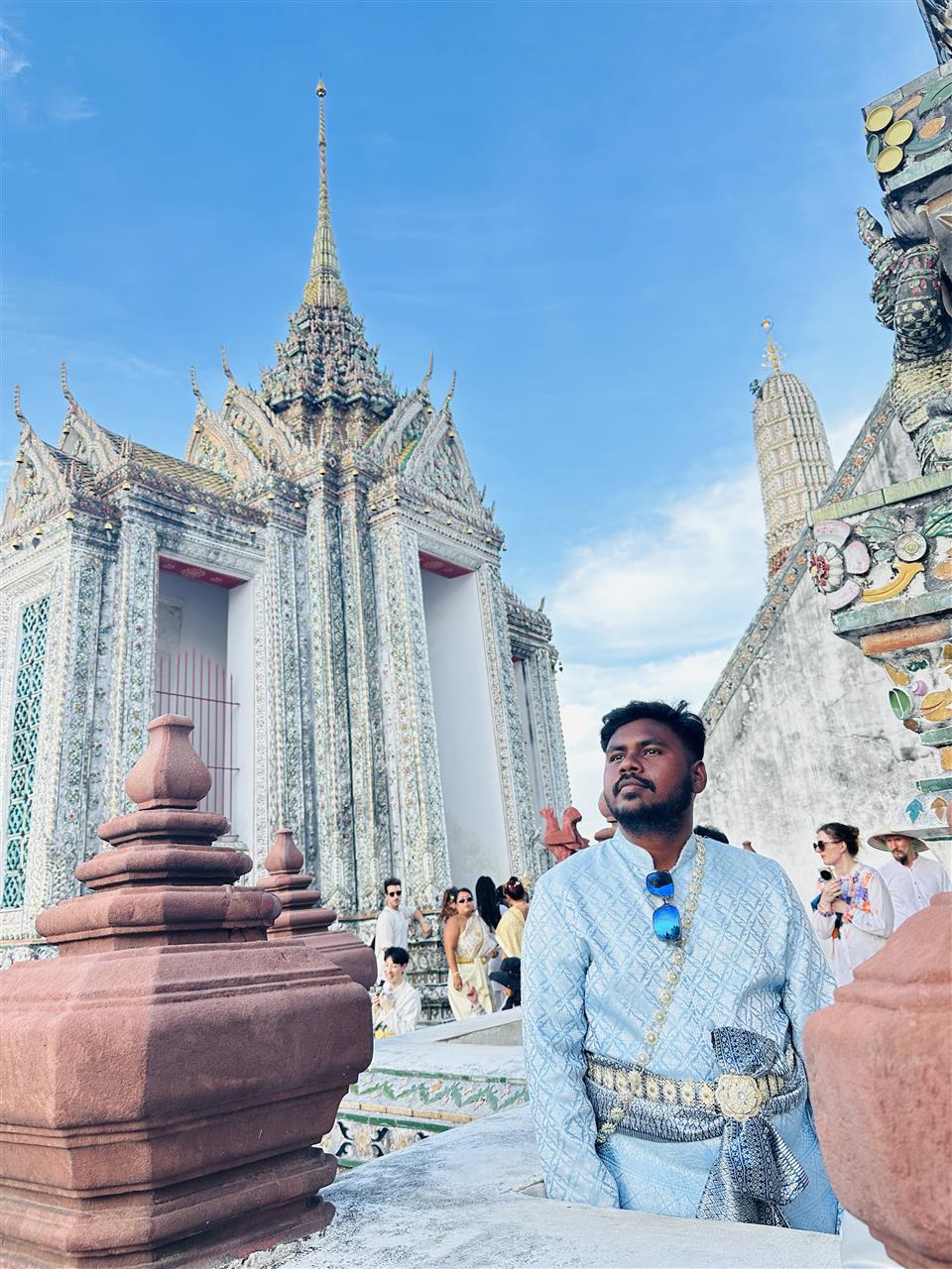 Visitor in traditional Thai dress at Wat Arun in Bangkok